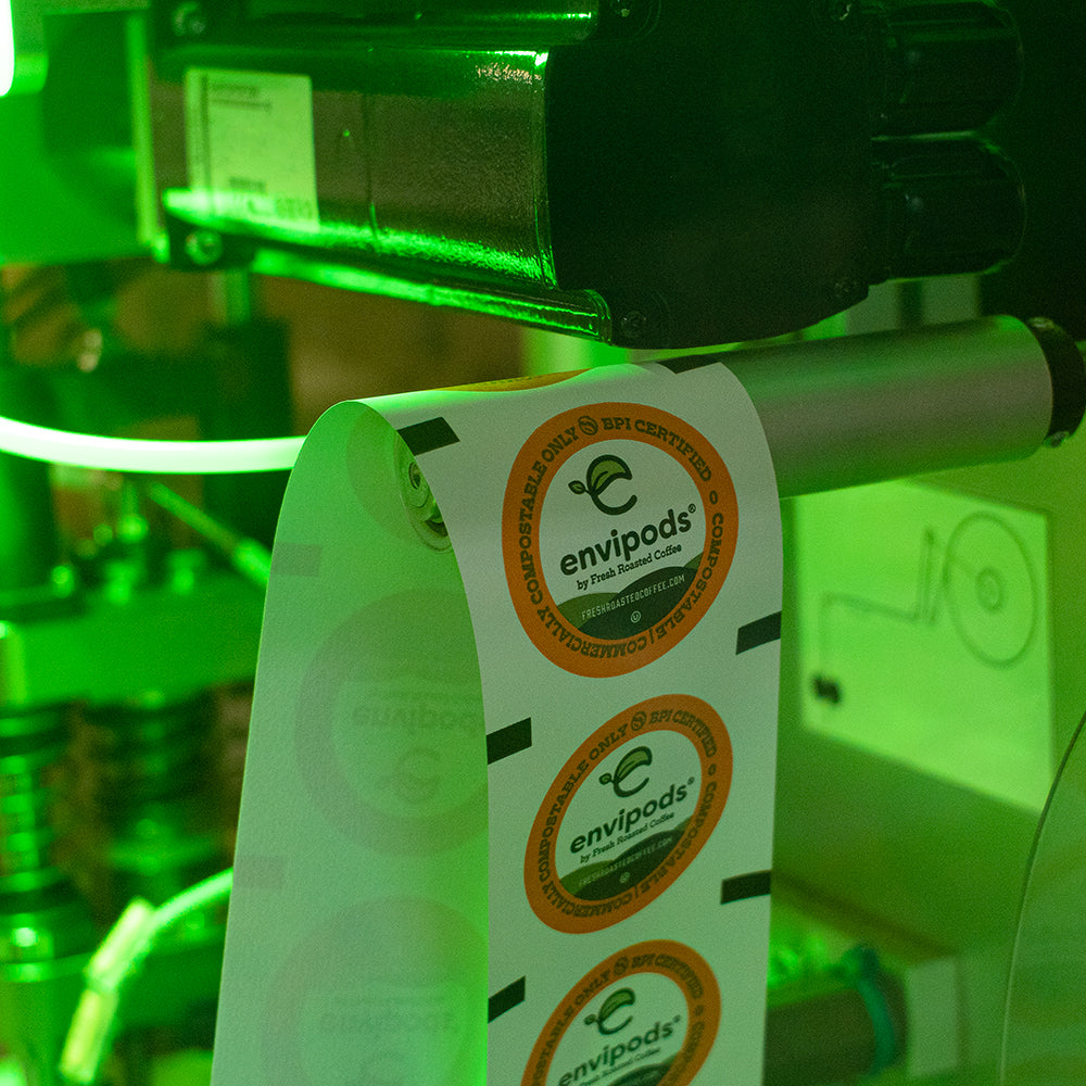 A strip of compostable pod lidding within the machine.