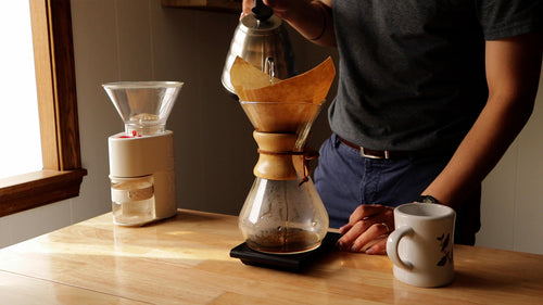 Brewing in a Chemex Classic on a scale next to a coffee grinder.