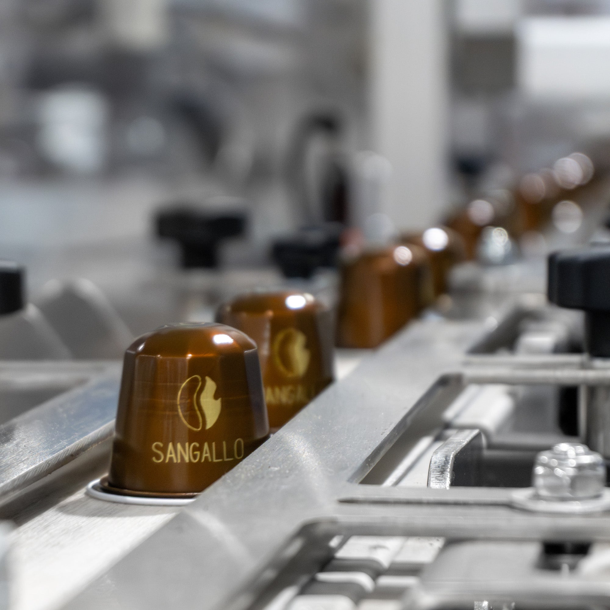 Fresh Roasted Coffee espresso capsule moving through production line.
