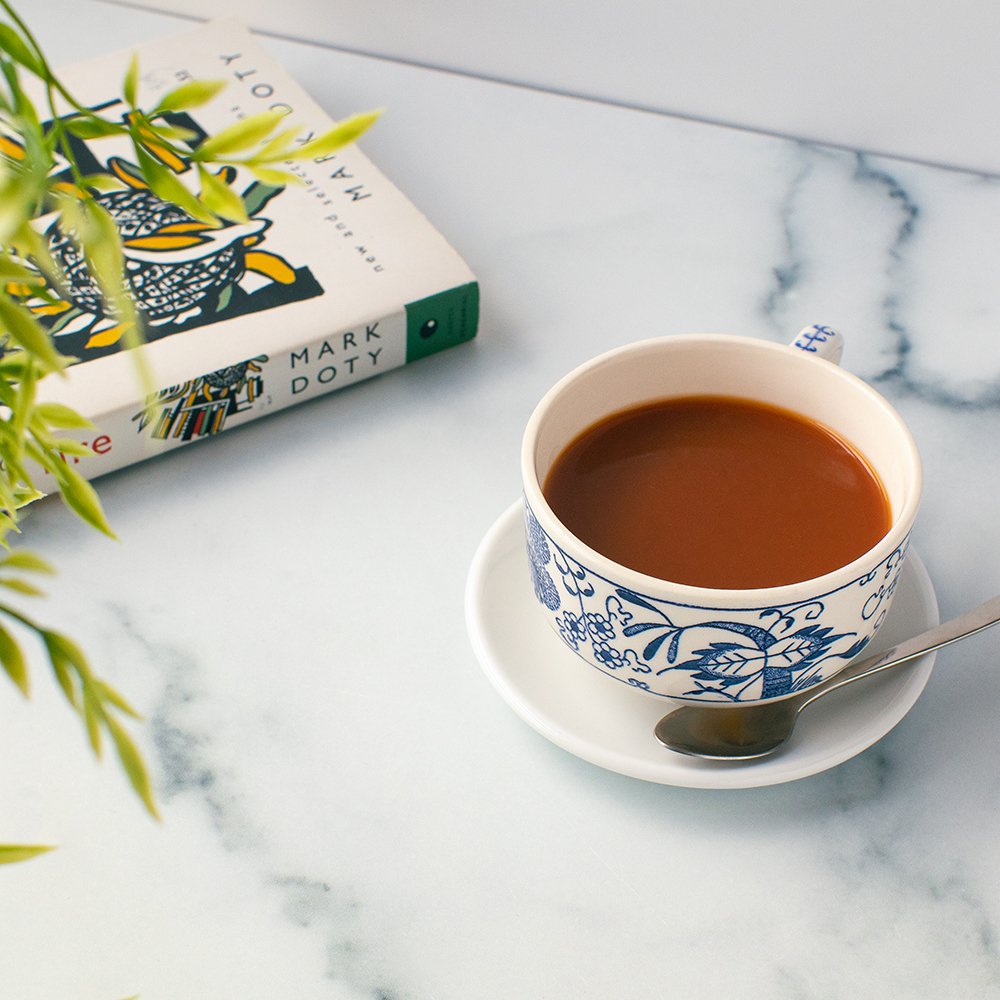 Freshly brewed cup of English Breakfast Organic Black Tea in a decorative teacup, offering smooth and bright tasting notes.