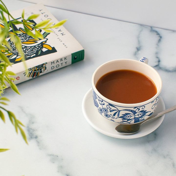 Freshly brewed cup of English Breakfast Organic Black Tea in a decorative teacup, offering smooth and bright tasting notes.
