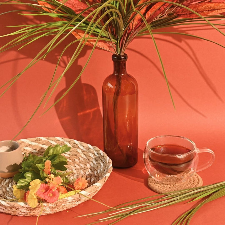 Positively Tea Company Organic Rooibos tea served in a glass cup on a warm-toned background, creating an inviting tea moment.