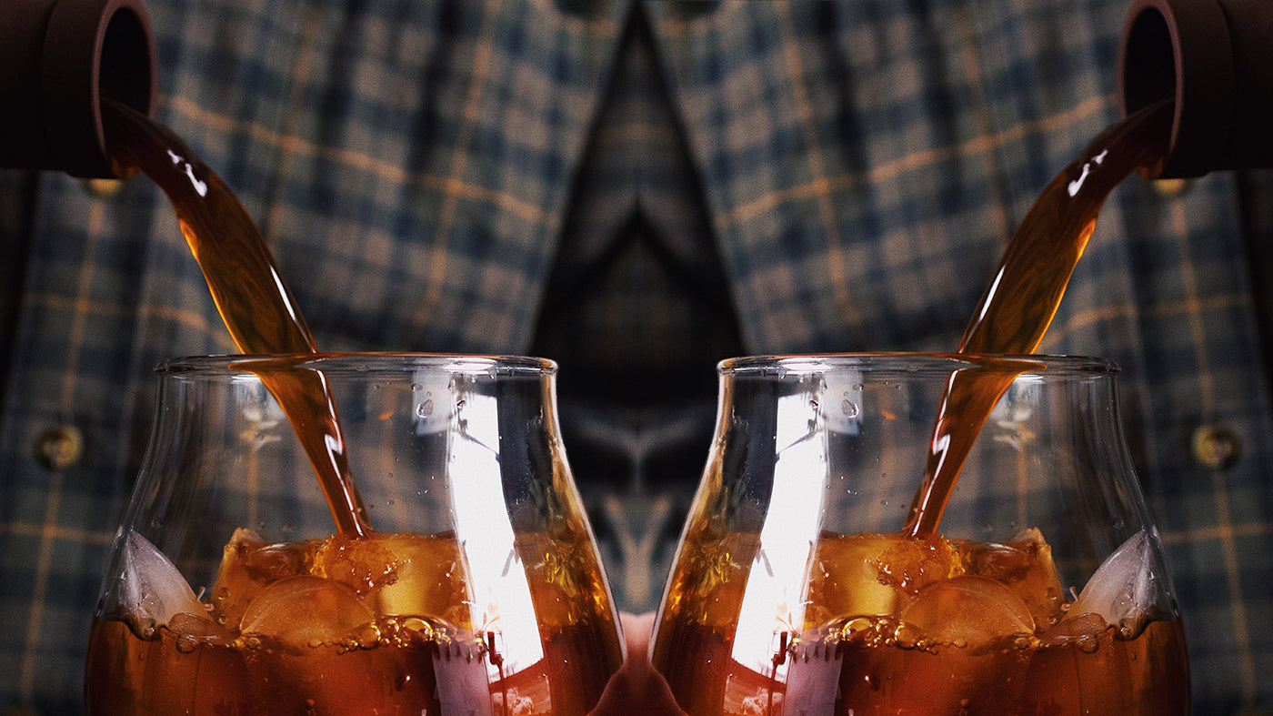 A mirrored image of cold brew being poured into an iced glass.
