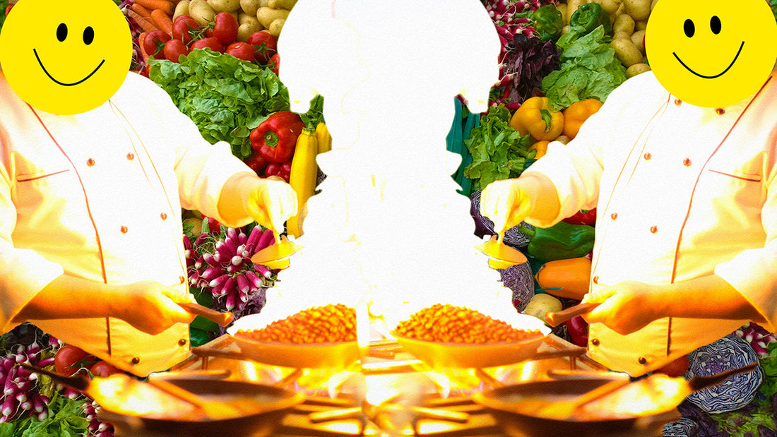 A chef mirrored, cooking coffee beans in a tall flame on a background of fresh vegetables.