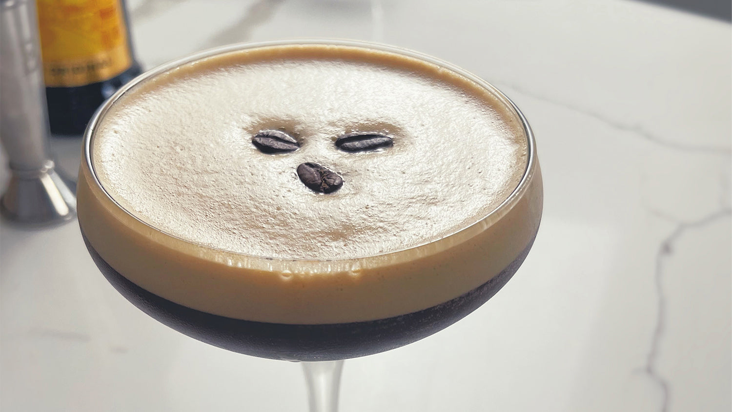 An espresso martini on a granite countertop.