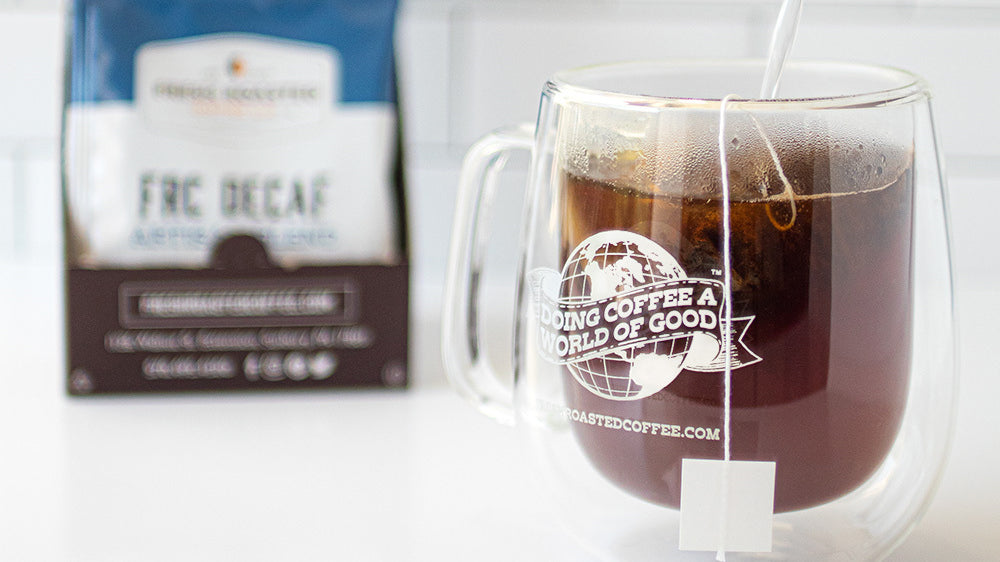 A double-walled mug, in which is an FRC Decaf sachet.