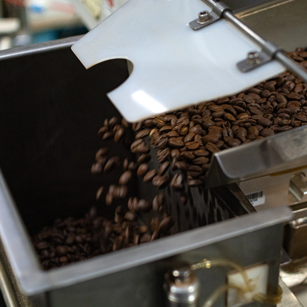Roasted coffee being portioned out for packing.