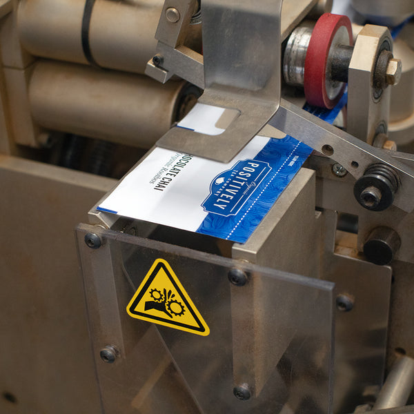 Tea bag machine punching out individually wrapped tea bags.