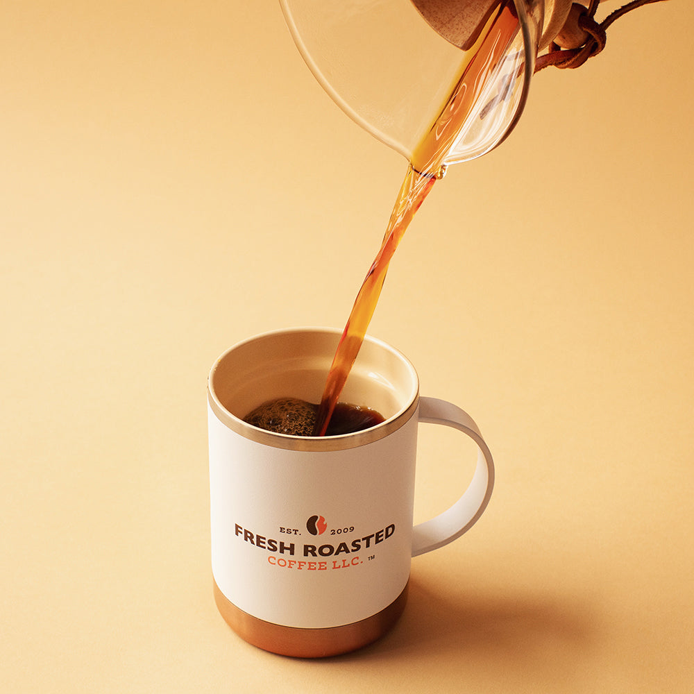 Pouring coffee from a Chemex into an Asobu Ultimate Mug.