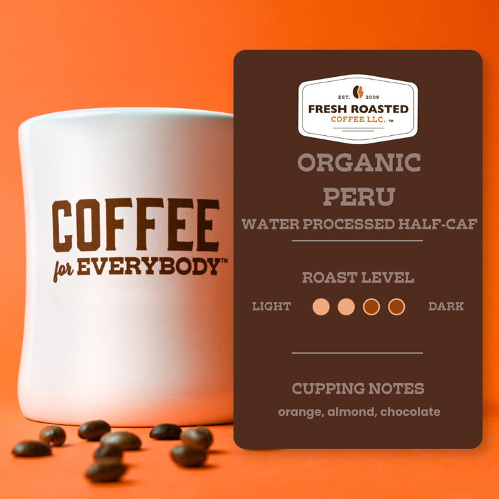 Fresh Roasted Coffee Peru Organic Half-Caf roast level and flavor profile card displayed next to a white coffee mug and coffee beans.